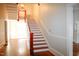 Bright foyer with hardwood floors and classic staircase with red trim at 208 Glenn St, Franklinton, NC 27525