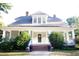 Charming home showcasing a covered porch and well-manicured landscaping at 208 Glenn St, Franklinton, NC 27525