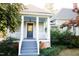 Welcoming front porch with painted wood stairs and railings, and mature plantings at 208 Glenn St, Franklinton, NC 27525