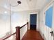 Second-floor hallway featuring hardwood floors and white railings at 208 Glenn St, Franklinton, NC 27525