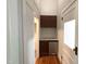 A hallway featuring a small refrigerator and cabinets, providing convenient storage at 208 Glenn St, Franklinton, NC 27525