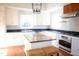 Bright kitchen with stainless steel appliances, granite countertops, and a butcher block island at 208 Glenn St, Franklinton, NC 27525