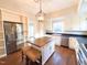 Light-filled kitchen boasting an island, stainless appliances, and custom cabinetry at 208 Glenn St, Franklinton, NC 27525