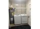 Modern laundry room includes a washer, dryer, and water heater at 208 Glenn St, Franklinton, NC 27525