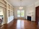 Bright living room with hardwood floors, built-in shelving, fireplace, and natural light at 208 Glenn St, Franklinton, NC 27525