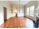 Open-concept living room with built-in shelving, chandelier, fireplace, and large windows at 208 Glenn St, Franklinton, NC 27525