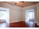 Bright, spacious living room featuring a wood ceiling, hardwood floors, and large windows at 208 Glenn St, Franklinton, NC 27525