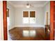Bright living room with hardwood floors, neutral walls, and large windows with shades at 208 Glenn St, Franklinton, NC 27525