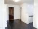 Spacious living area with dark tile flooring, white wainscoting, and access to other rooms at 208 Glenn St, Franklinton, NC 27525