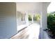 A view of the long porch with a painted wood floor and ceiling at 208 Glenn St, Franklinton, NC 27525