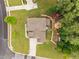 Aerial view of a private backyard featuring a fire pit, stone pathway, and lush green landscaping at 21 Botanical Way, Pittsboro, NC 27312