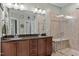 Well-appointed bathroom with double vanities, granite countertops, and a tiled walk-in shower at 21 Botanical Way, Pittsboro, NC 27312