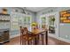 Inviting dining area with wood table, seating for four, and a view to the patio and backyard at 21 Botanical Way, Pittsboro, NC 27312
