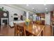 Open dining area with seating for four, seamlessly connecting to the living room, staircase, and kitchen at 21 Botanical Way, Pittsboro, NC 27312