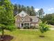 Stunning two-story brick home with a well-maintained lawn and lush landscaping at 21 Botanical Way, Pittsboro, NC 27312