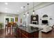 Open-concept kitchen with center island and bar stool seating flows into the dining and living areas at 21 Botanical Way, Pittsboro, NC 27312