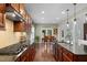 Spacious kitchen features dark wood cabinetry, granite countertops, a gas range, and an adjacent dining area at 21 Botanical Way, Pittsboro, NC 27312
