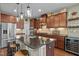 Modern kitchen with a center island, granite countertops, stainless steel appliances, and a wine refrigerator at 21 Botanical Way, Pittsboro, NC 27312