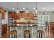 Well-appointed kitchen features a center island with bar seating, stylish pendant lighting, and abundant cabinet space at 21 Botanical Way, Pittsboro, NC 27312