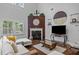 Bright living room featuring a fireplace, hardwood floors, and large windows for ample natural light at 21 Botanical Way, Pittsboro, NC 27312