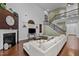 Open-concept living room with hardwood floors, fireplace, soaring ceilings, and stylish decor at 21 Botanical Way, Pittsboro, NC 27312