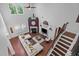 Open-concept living room features wood floors, fireplace, and staircase at 21 Botanical Way, Pittsboro, NC 27312