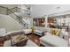 Open-concept living room showcasing staircase, hardwood floors, kitchen and dining room at 21 Botanical Way, Pittsboro, NC 27312