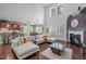 Spacious living room with hardwood floors, fireplace, and open layout to the kitchen and dining area at 21 Botanical Way, Pittsboro, NC 27312