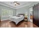 Serene primary bedroom with tray ceilings, hardwood floors, and an en-suite bathroom at 21 Botanical Way, Pittsboro, NC 27312