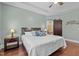 Cozy primary bedroom featuring a tray ceiling, hardwood floors, and easy access to the attached bathroom at 21 Botanical Way, Pittsboro, NC 27312