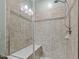 Modern tiled shower features glass door and shower head with handheld sprayer at 21 Botanical Way, Pittsboro, NC 27312