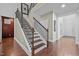 Beautiful home staircase featuring dark wood treads, white risers, and decorative metal balusters at 21 Botanical Way, Pittsboro, NC 27312
