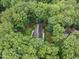 Aerial view of a home surrounded by trees with landscaped gardens and a winding driveway at 2300 Valley Forge Dr, Raleigh, NC 27615