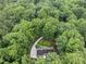 Aerial view of a property surrounded by dense trees and an elaborate garden at 2300 Valley Forge Dr, Raleigh, NC 27615