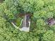 An aerial view of a secluded home surrounded by lush green trees and landscape at 2300 Valley Forge Dr, Raleigh, NC 27615