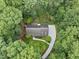 Aerial shot of a home surrounded by lush trees featuring a winding driveway at 2300 Valley Forge Dr, Raleigh, NC 27615