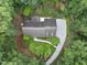 Overhead view of roof and landscaped yard, surrounded by lush trees and winding driveway at 2300 Valley Forge Dr, Raleigh, NC 27615