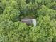 Aerial view showcases a home surrounded by green trees with a circular driveway at 2300 Valley Forge Dr, Raleigh, NC 27615
