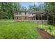 Expansive backyard featuring a deck, screened-in porch, and lush landscaping at 2300 Valley Forge Dr, Raleigh, NC 27615