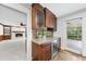 Wet bar including granite countertops, wine fridge and sliding door to exterior at 2300 Valley Forge Dr, Raleigh, NC 27615