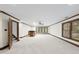 Spacious basement area with a bar and wooden accents, lit by a modern ceiling fan at 2300 Valley Forge Dr, Raleigh, NC 27615