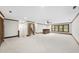 Basement space with a bar area, neutral carpet, and wood trim throughout at 2300 Valley Forge Dr, Raleigh, NC 27615