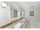 Bright bathroom with a dual sink vanity with granite countertop and tile flooring at 2300 Valley Forge Dr, Raleigh, NC 27615