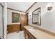 Traditional bathroom featuring a wood vanity and paneling, with a tile floor and glass enclosed shower at 2300 Valley Forge Dr, Raleigh, NC 27615
