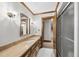 Traditional bathroom featuring a wood vanity and paneling, with a tile floor and glass enclosed shower at 2300 Valley Forge Dr, Raleigh, NC 27615