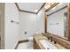 Cozy bathroom with wood accents, granite countertop, and a unique mirror at 2300 Valley Forge Dr, Raleigh, NC 27615