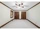 This carpeted bedroom features a ceiling fan, paneled doors and trim, and neutral walls at 2300 Valley Forge Dr, Raleigh, NC 27615