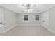 Neutral bedroom featuring plush carpet, two windows with blinds and a ceiling fan with lighting at 2300 Valley Forge Dr, Raleigh, NC 27615
