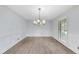 Dining room with hardwood floors, bright light and updated chandelier at 2300 Valley Forge Dr, Raleigh, NC 27615