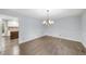Formal dining room with hardwood floors and elegant chandelier at 2300 Valley Forge Dr, Raleigh, NC 27615